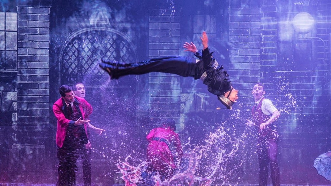 Performer mid-air during WOW: The Vegas Spectacular show with water effects.