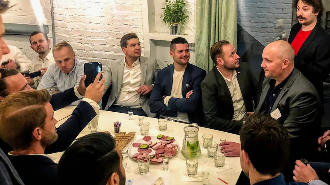 Group enjoying vodka tasting with snacks in Wroclaw.