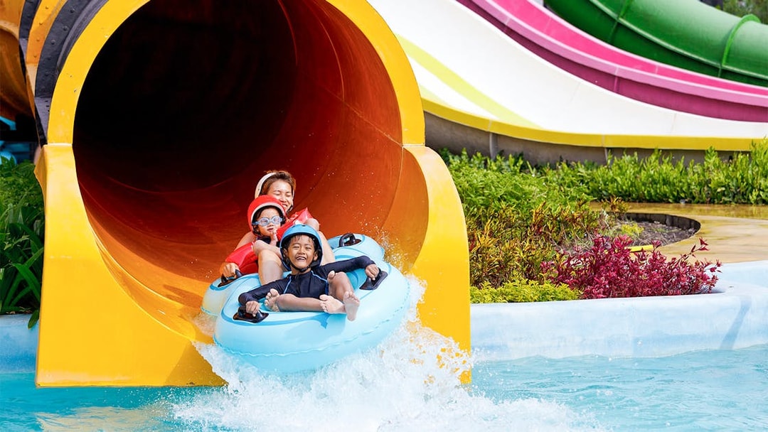 Family enjoying water slide at Yas Waterworld Abu Dhabi.