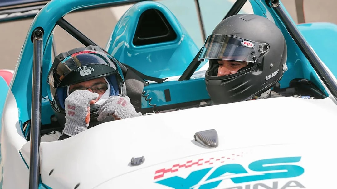 Two people in a race car at Yas Marina Circuit for YAS Radical SST Passenger experience.