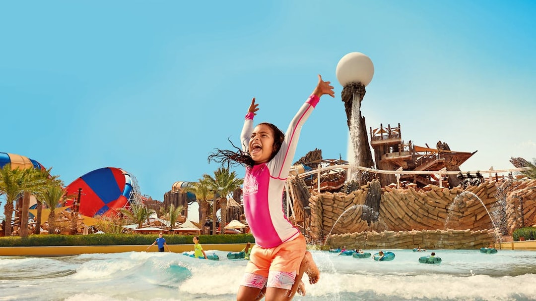 Kid jumping in Amwaj Wave Pool at YAS Waterworld, Abu Dhabi.