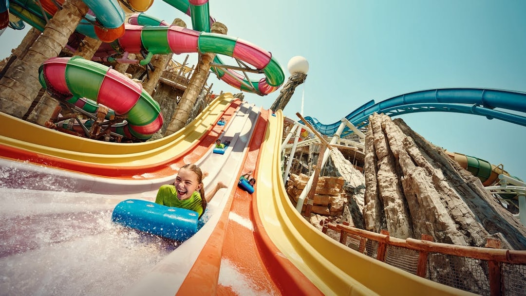 Girl sliding on Sebag water slide at YAS Waterworld, Abu Dhabi.