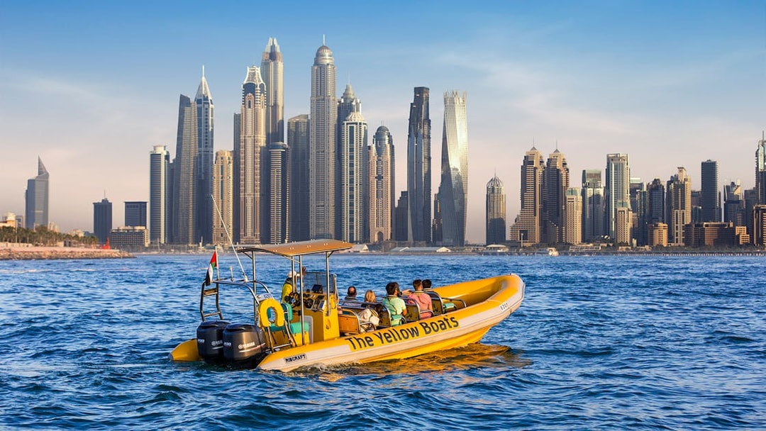 Speedboat tour in Dubai Marina with city skyline in the background.