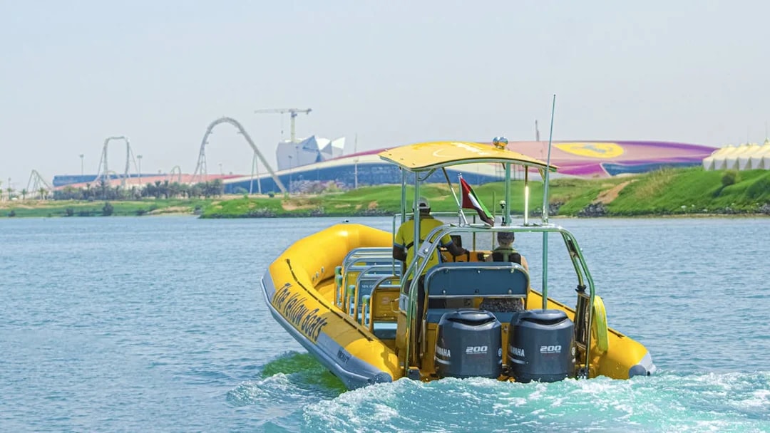 Speedboat on Yas Island tour with theme park in background.