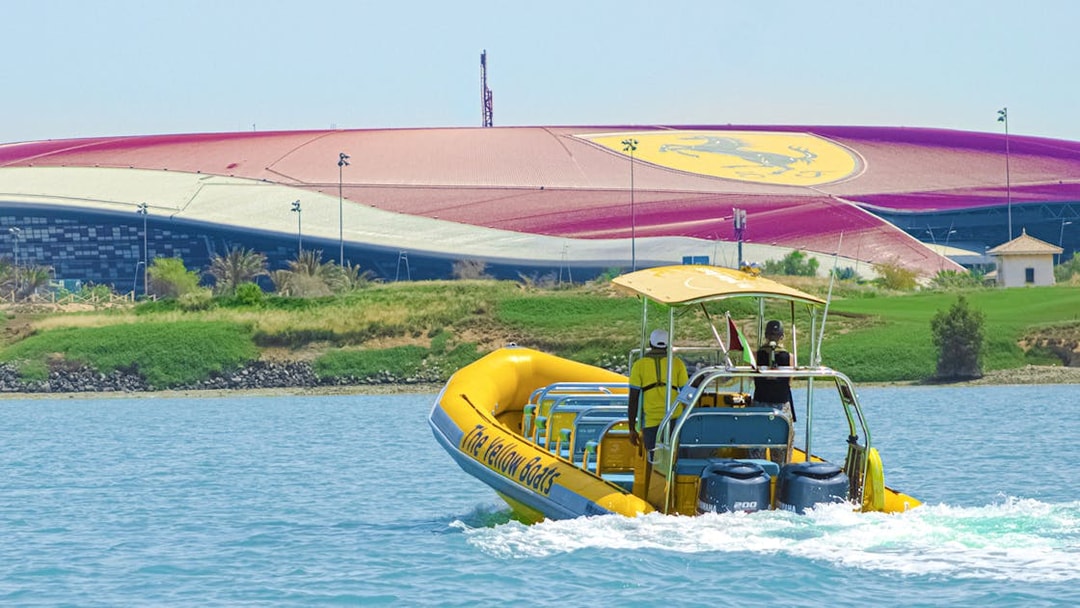 Speedboat on Yas Island tour passing Ferrari World Abu Dhabi.