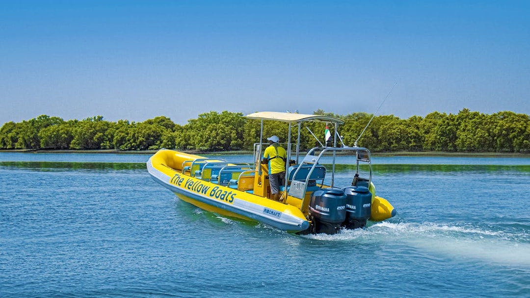 Speedboat on Yas Island tour with lush greenery in the background.