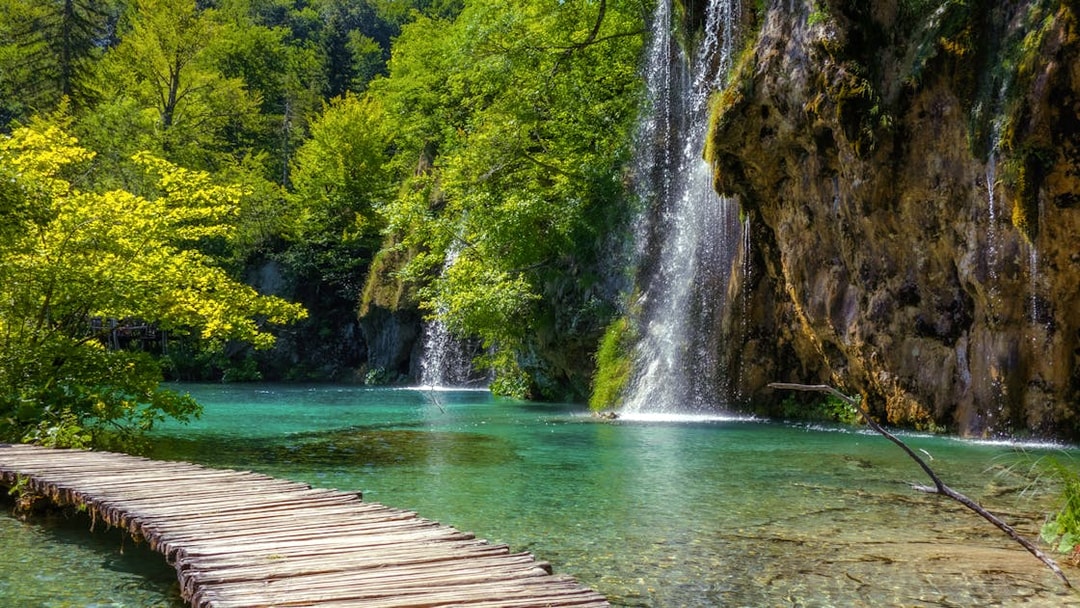 Wooden path beside waterfalls at Plitvice Lakes National Park, Croatia.