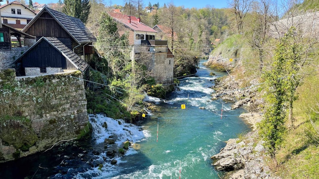 Rastoke Village river with traditional stone and wooden houses, part of the Plitvice Lakes tour.