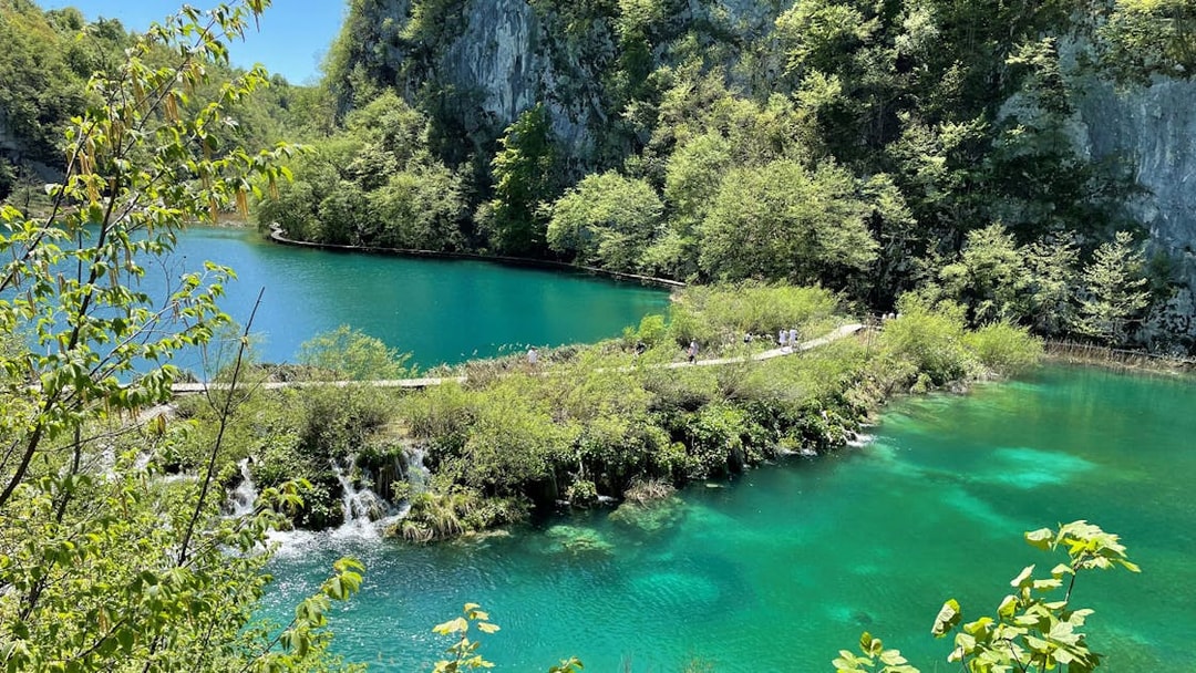 Plitvice Lakes National Park turquoise lake and lush greenery, Croatia.
