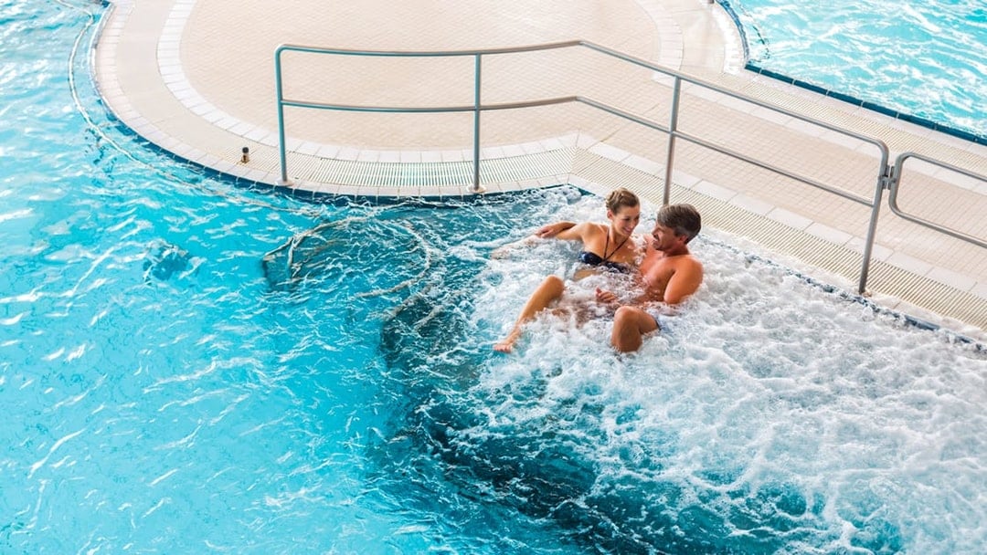 Couple relaxing in a jacuzzi at Chocholow Thermal Baths, Poland.