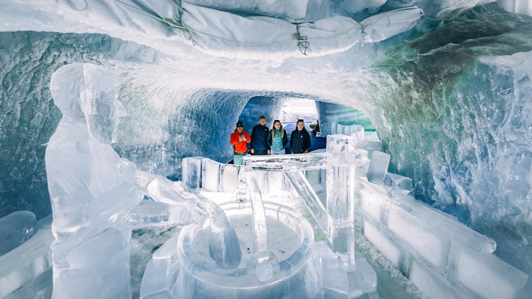 Visitors exploring ice sculptures inside Glacier Paradise.