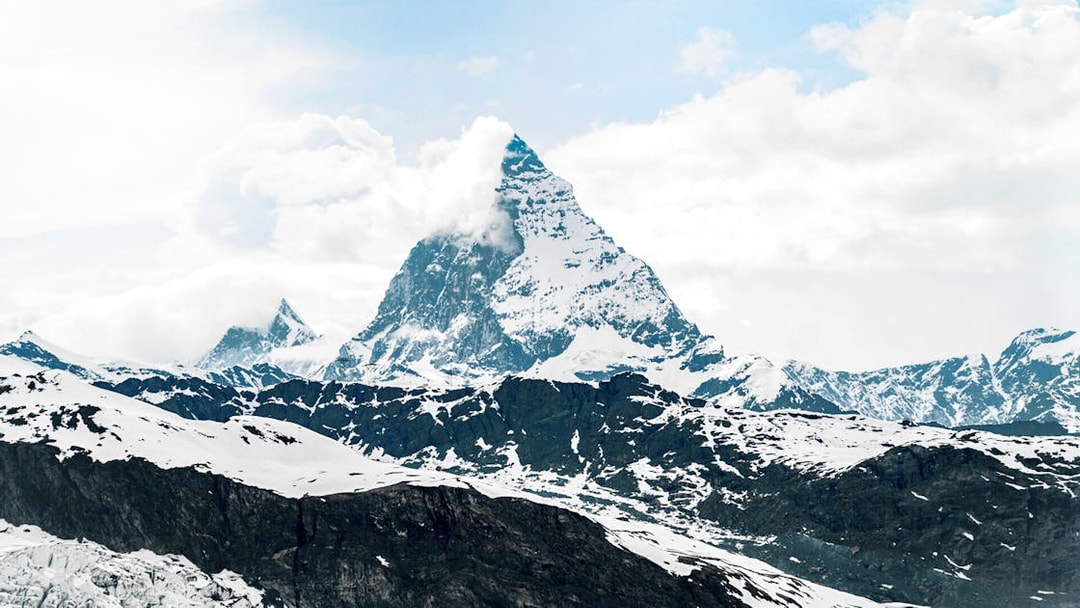 Matterhorn peak view from cable car, snow-covered Alps, Switzerland.