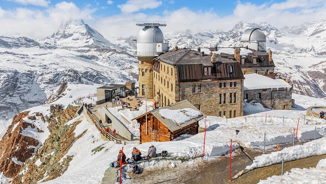 Kulmhotel Gornergrat with observatory and snowy Matterhorn backdrop, Zermatt.