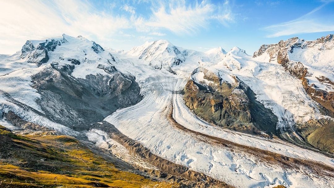 Dufourspitze Monte Rosa view from platform with snow-covered peaks and glacier.