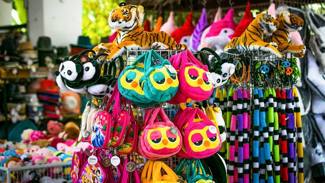 Plush toys and colorful bags at Sunway Lagoon Theme Park gift shop.